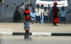 A boy on roller blades watches as he waits for Pope Benedict XVI to pass in Luanda, Angola, during the second leg of the pontiff's trip to Africa. (CNS photo: Alessandro Bianchi, Reuters) 