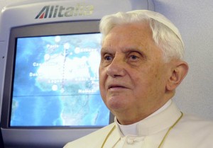 Pope Benedict XVI listens to journalists' questions during his flight from Rome to Cameroon. (CNS photo/Alessandro Bianchi, Reuters)