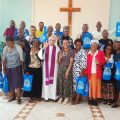 Dominican Father Mark James with some of his Deaf congregants after Mass.