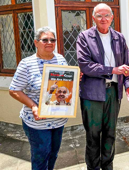 Pamela Davids and Cardinal Stephen Brislin with a framed copy of the first Southern Cross magazine signed by Pope Francis