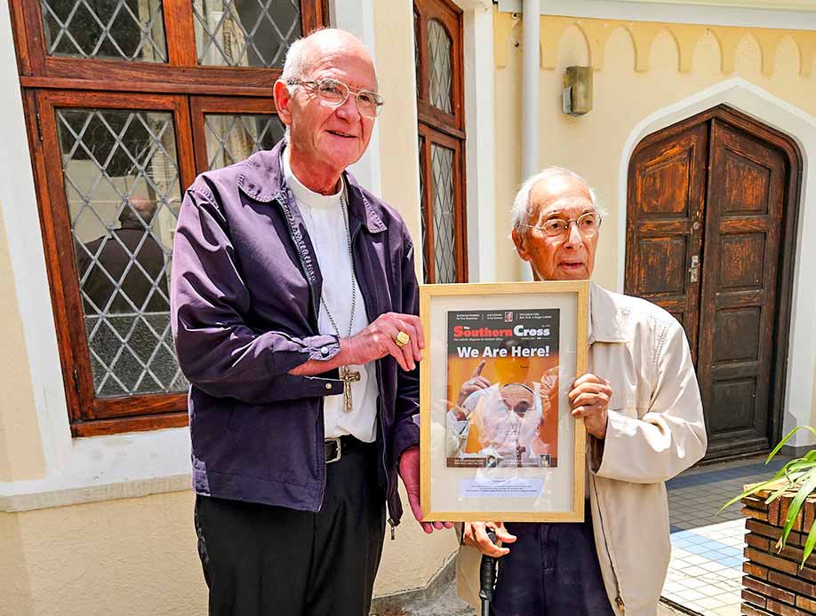 Cardinal Stephen Brislin and Sydney Duval with a framed copy of The Southern Cross signed by Pope Francis a gift to Duval for his long service on the board of directors of the Catholic publication